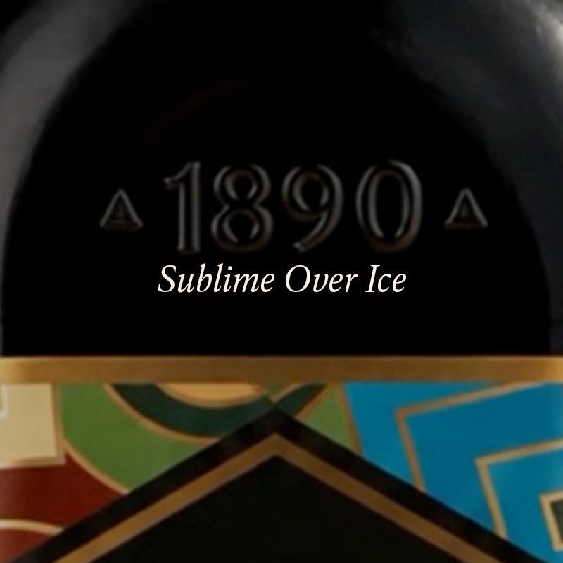 Close-up of a dark product surface with embossed '1890' and the text 'Sublime Over Ice' over a colorful patterned section below.