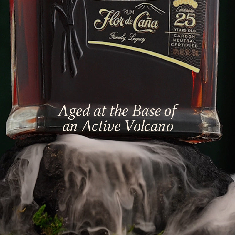 Flor de Caána rum bottle with volcanic smoke effect on a dark background